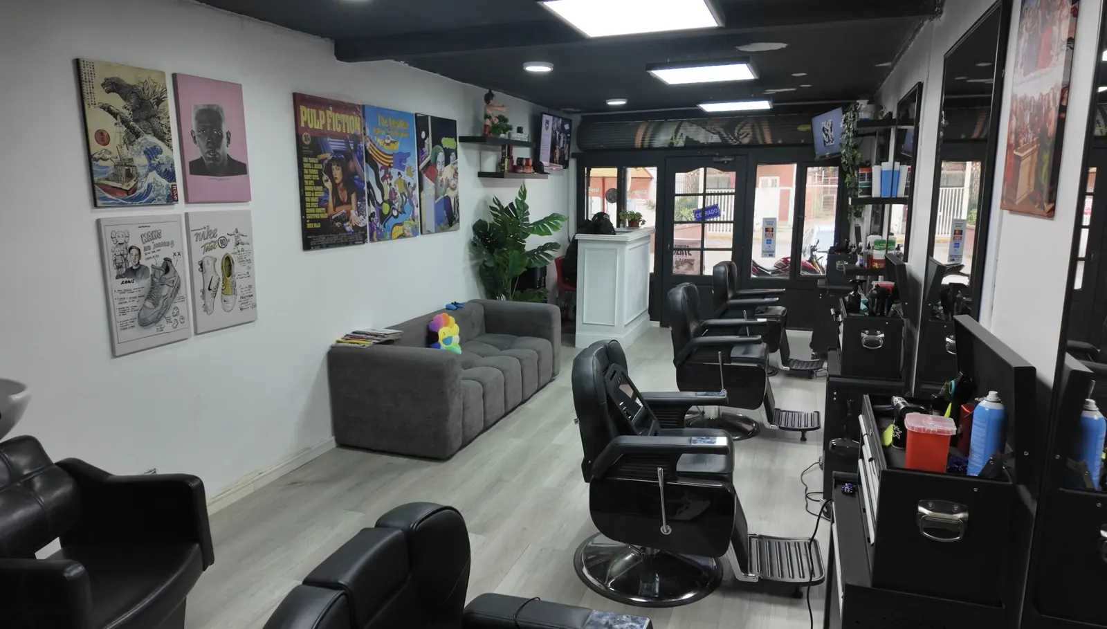 Zona de espera de la barbería con arte en las paredes